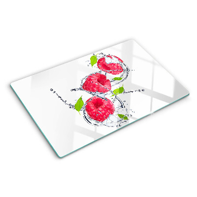 Chopping board glass Raspberries in water with leaves