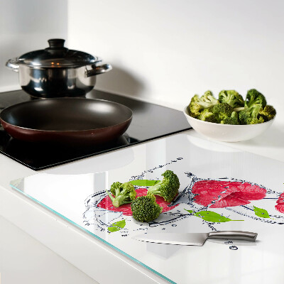 Chopping board glass Raspberries in water with leaves