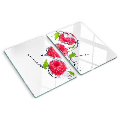 Chopping board glass Raspberries in water with leaves