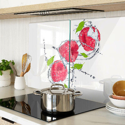Chopping board glass Raspberries in water with leaves