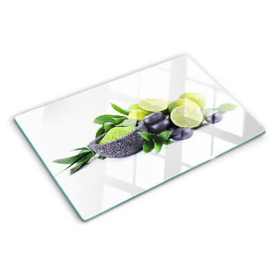 Chopping board glass Lemons and grapes on a green background