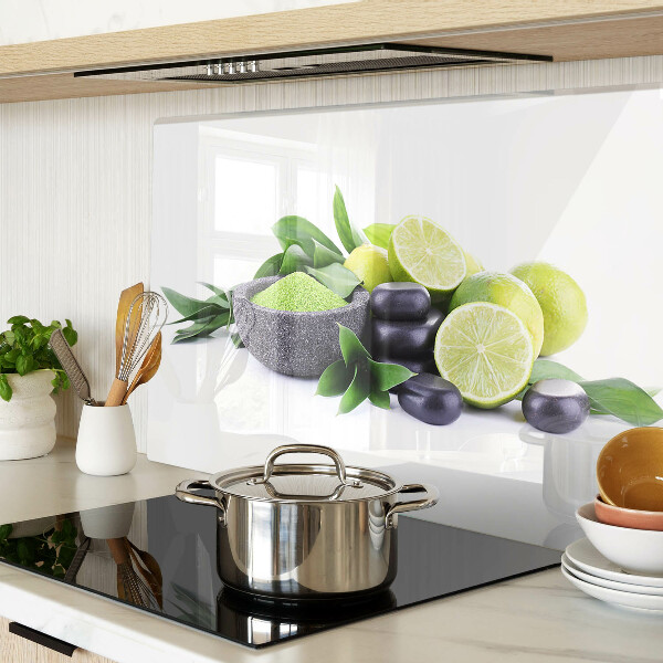 Chopping board glass Lemons and grapes on a green background