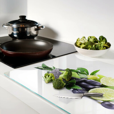 Chopping board glass Lemons and grapes on a green background