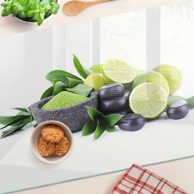 Chopping board glass Lemons and grapes on a green background