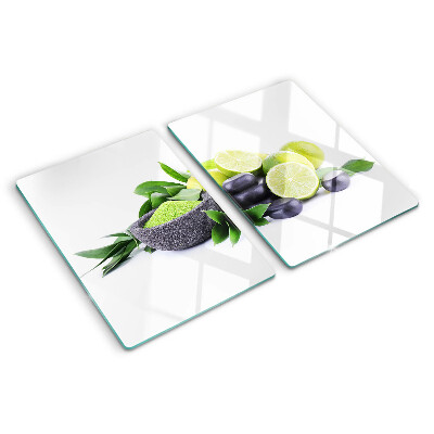 Chopping board glass Lemons and grapes on a green background