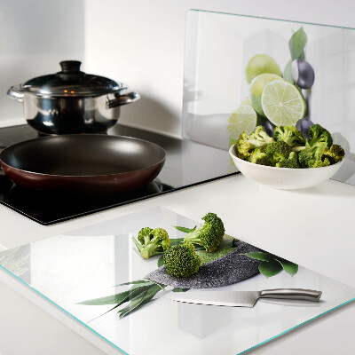 Chopping board glass Lemons and grapes on a green background