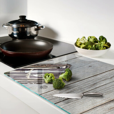 Chopping board glass Rustic cutlery on a wooden background