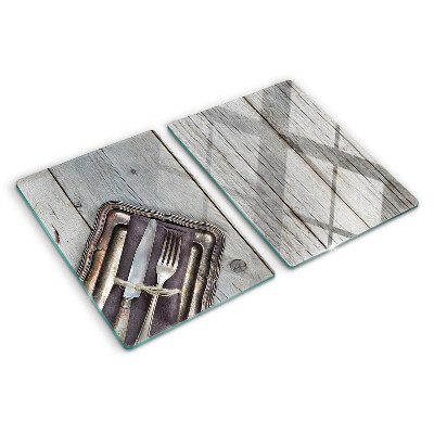 Chopping board glass Rustic cutlery on a wooden background