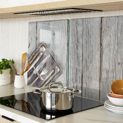 Chopping board glass Rustic cutlery on a wooden background