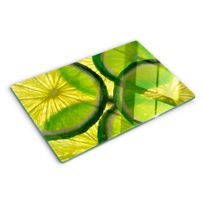 Glass kitchen board Lime slices on a green background