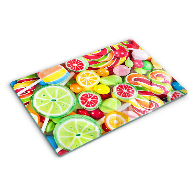 Glass cutting board Sweet candies and fruits