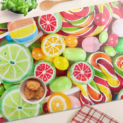 Glass cutting board Sweet candies and fruits
