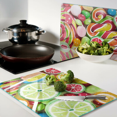 Glass cutting board Sweet candies and fruits