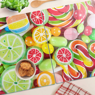 Glass cutting board Sweet candies and fruits