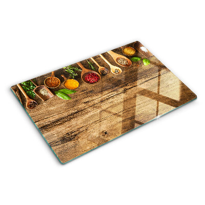 Glass kitchen board Spices and herbs on a wooden background
