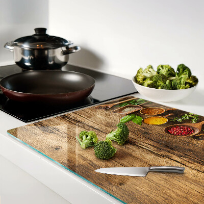 Glass kitchen board Spices and herbs on a wooden background