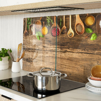 Glass kitchen board Spices and herbs on a wooden background