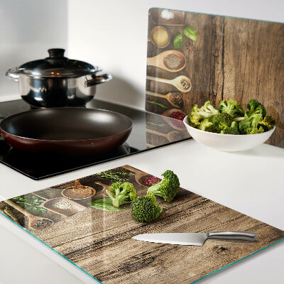 Glass kitchen board Spices and herbs on a wooden background