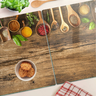 Glass kitchen board Spices and herbs on a wooden background