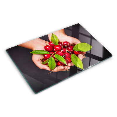 Chopping board Red cherries in hands