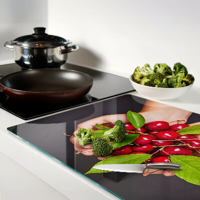 Chopping board Red cherries in hands