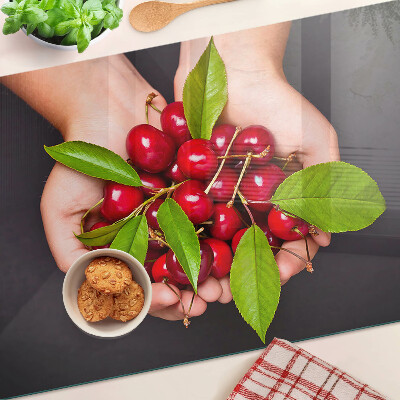 Chopping board Red cherries in hands