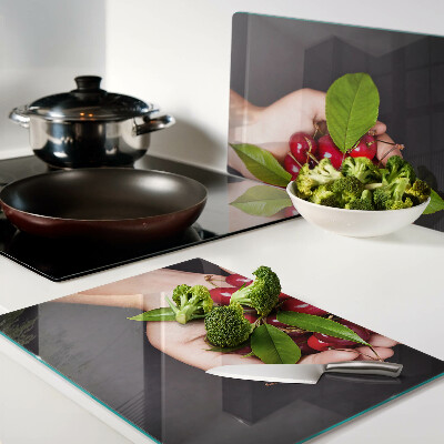 Chopping board Red cherries in hands