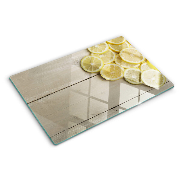 Cutting board Lemon slices on a wooden background