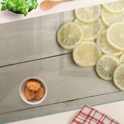 Cutting board Lemon slices on a wooden background