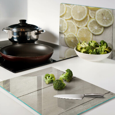 Cutting board Lemon slices on a wooden background