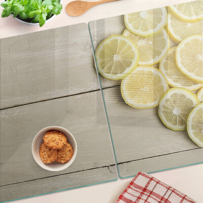 Cutting board Lemon slices on a wooden background