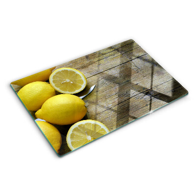Cutting board Lemons on a wooden background