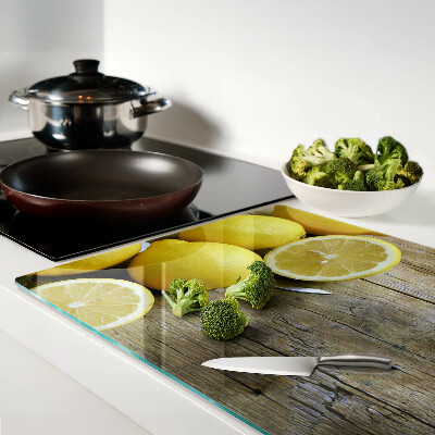 Cutting board Lemons on a wooden background