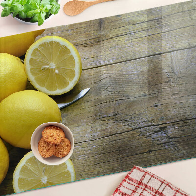 Cutting board Lemons on a wooden background