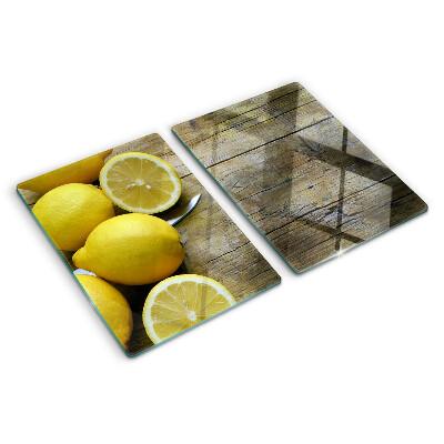 Cutting board Lemons on a wooden background
