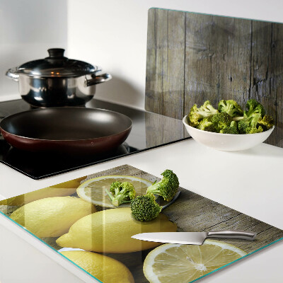 Cutting board Lemons on a wooden background