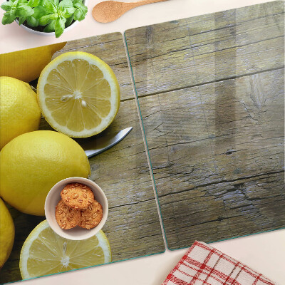 Cutting board Lemons on a wooden background