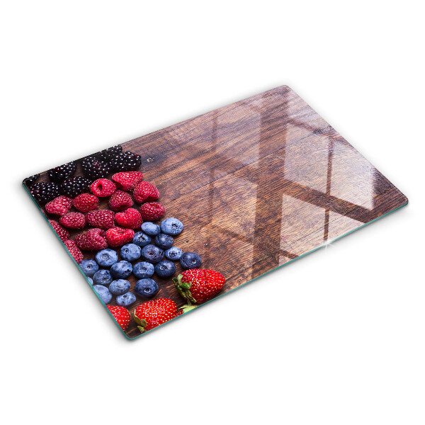 Chopping board Forest fruits on a wooden background