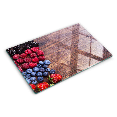 Chopping board Forest fruits on a wooden background