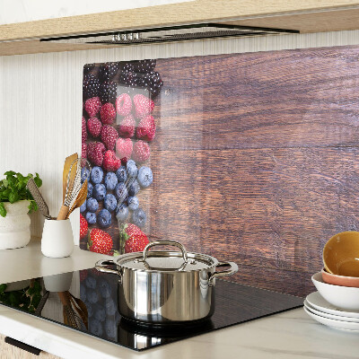 Chopping board Forest fruits on a wooden background
