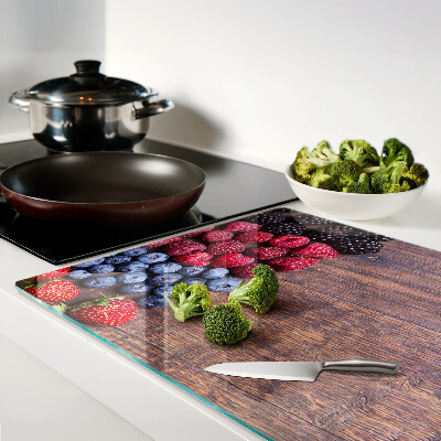 Chopping board Forest fruits on a wooden background
