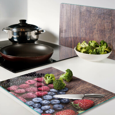Chopping board Forest fruits on a wooden background