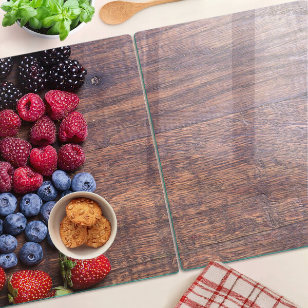 Chopping board Forest fruits on a wooden background