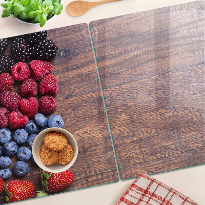 Chopping board Forest fruits on a wooden background