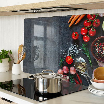 Glass cutting board Vegetables and spices on a dark background
