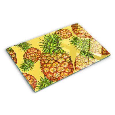 Glass kitchen board Pineapples on a yellow background