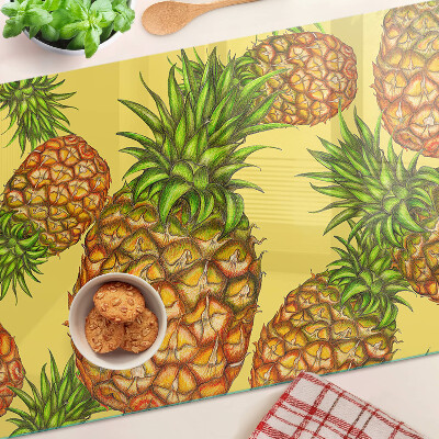 Glass kitchen board Pineapples on a yellow background