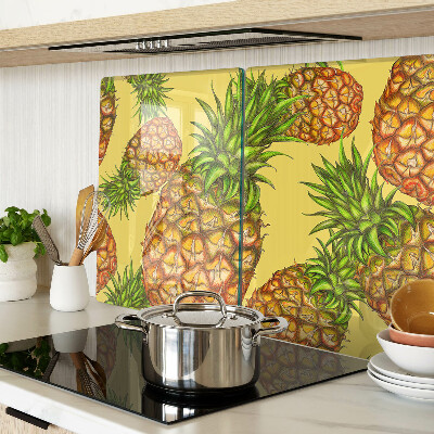 Glass kitchen board Pineapples on a yellow background