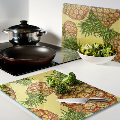 Glass kitchen board Pineapples on a yellow background