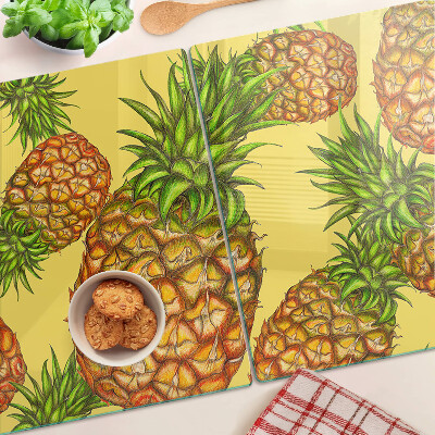 Glass kitchen board Pineapples on a yellow background